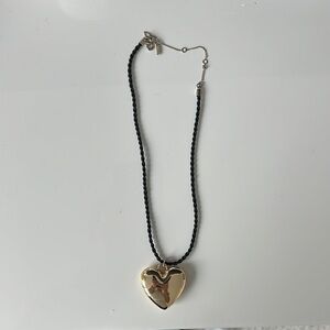 Black and gold puffy heart necklace 
Scratches on heart